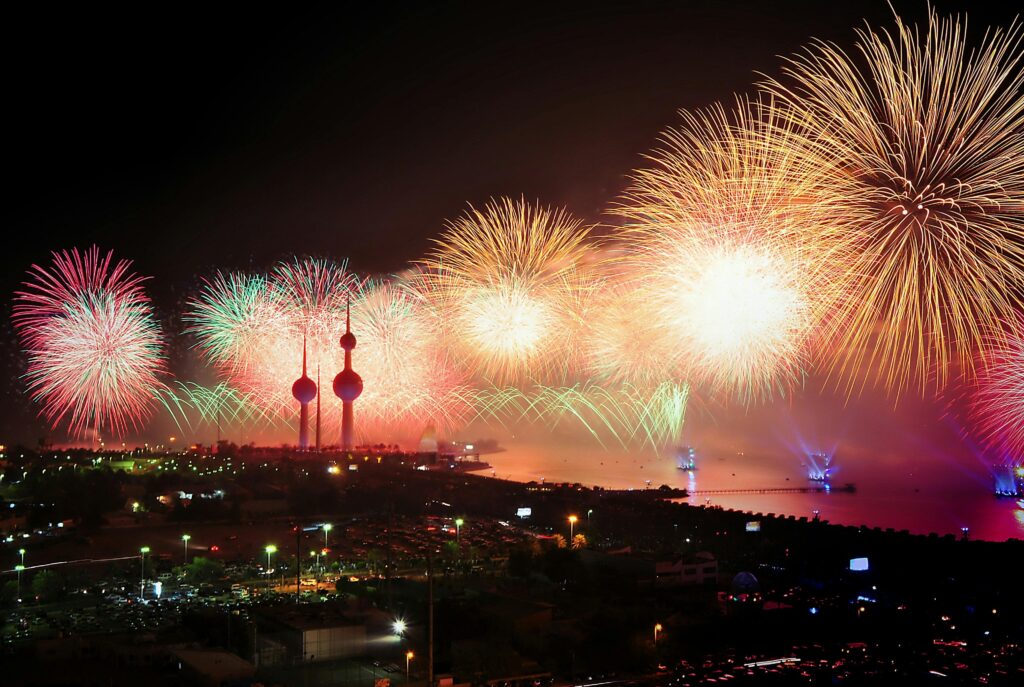 Colorful fireworks illuminate Kuwait Towers, celebrating a night of joy and festivities.