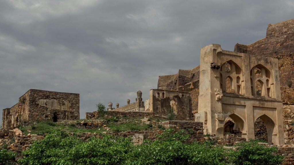 Explore the historic Golconda Fort ruins under cloudy skies in Hyderabad, India.